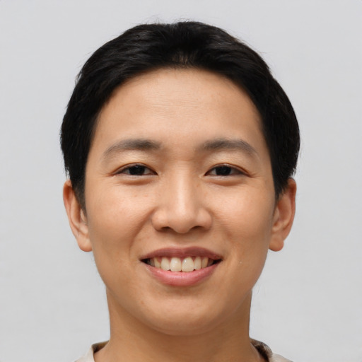 Joyful asian young-adult female with short  brown hair and brown eyes