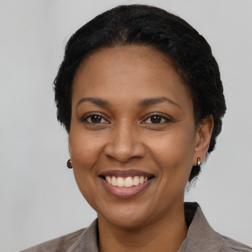 Joyful latino adult female with short  black hair and brown eyes