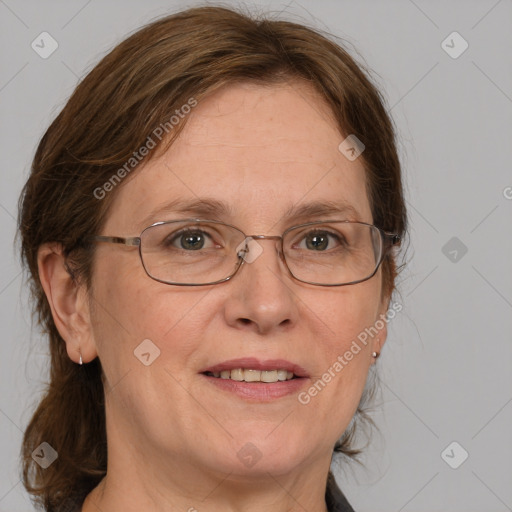 Joyful white adult female with medium  brown hair and blue eyes