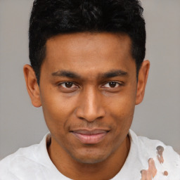 Joyful latino young-adult male with short  brown hair and brown eyes