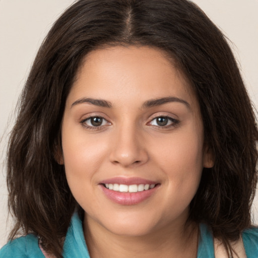 Joyful white young-adult female with long  brown hair and brown eyes