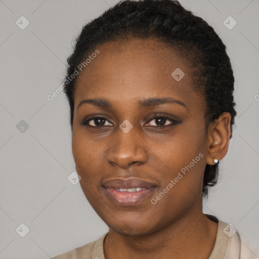 Joyful black young-adult female with short  black hair and brown eyes