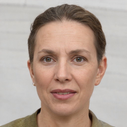 Joyful white adult female with short  brown hair and grey eyes