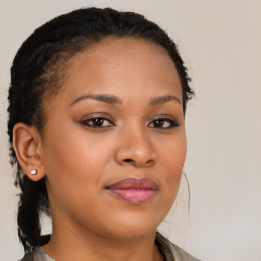 Joyful black young-adult female with long  brown hair and brown eyes