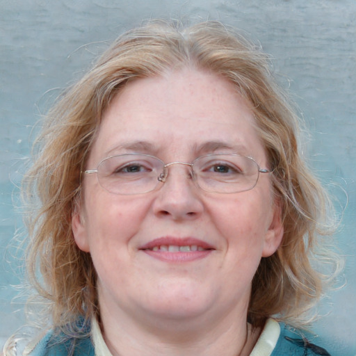 Joyful white adult female with medium  brown hair and blue eyes