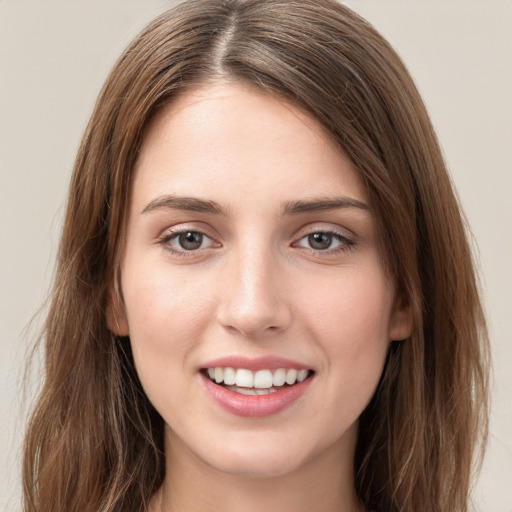 Joyful white young-adult female with long  brown hair and green eyes