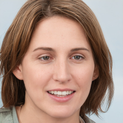 Joyful white young-adult female with medium  brown hair and green eyes