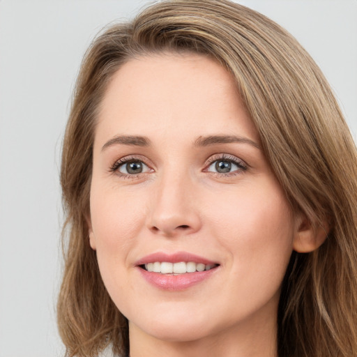 Joyful white young-adult female with long  brown hair and green eyes