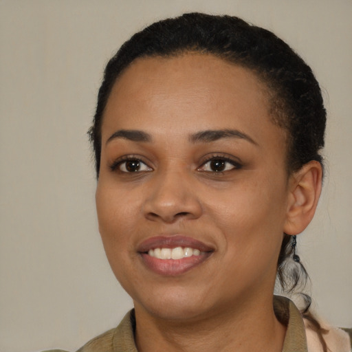 Joyful black young-adult female with short  brown hair and brown eyes
