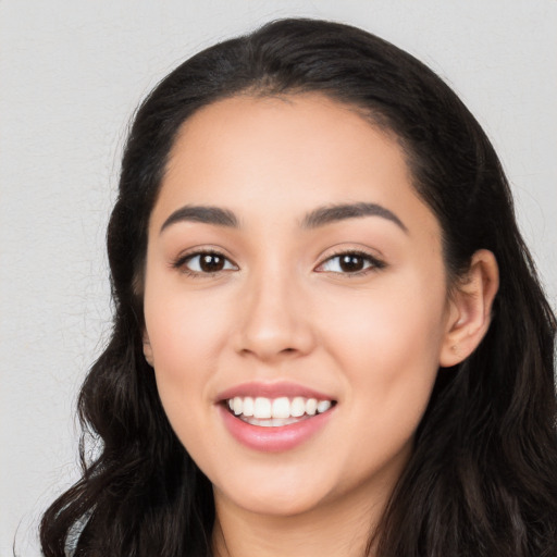 Joyful white young-adult female with long  black hair and brown eyes