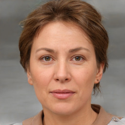 Joyful white adult female with short  brown hair and grey eyes