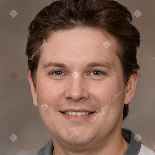 Joyful white adult male with short  brown hair and brown eyes