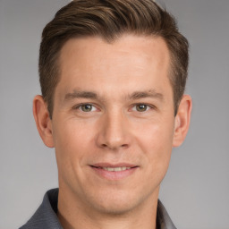 Joyful white young-adult male with short  brown hair and grey eyes