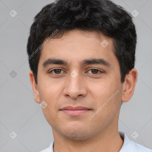 Joyful white young-adult male with short  black hair and brown eyes