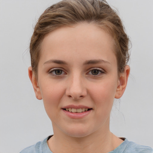 Joyful white child female with short  brown hair and grey eyes