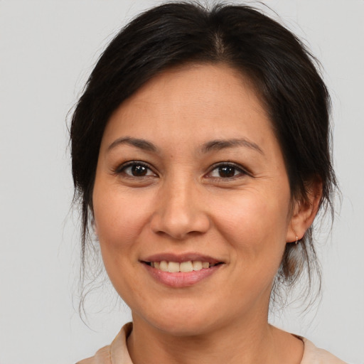 Joyful asian adult female with medium  brown hair and brown eyes