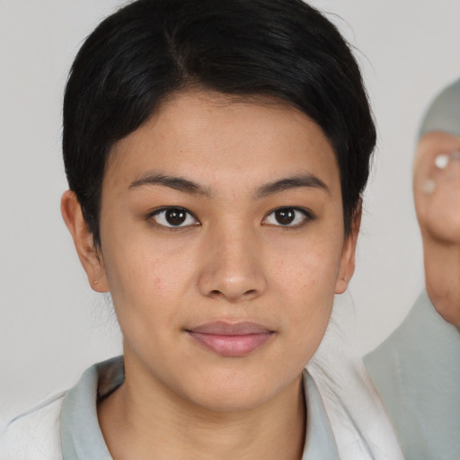 Joyful asian young-adult female with medium  brown hair and brown eyes
