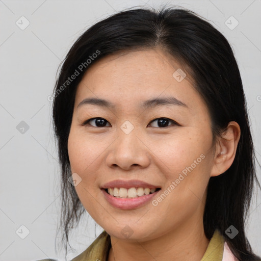 Joyful asian young-adult female with medium  brown hair and brown eyes