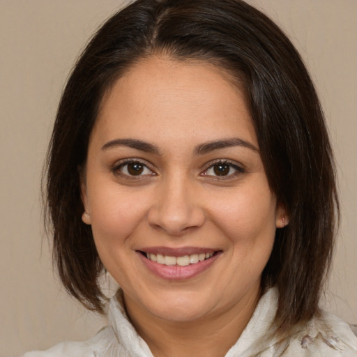 Joyful white young-adult female with medium  brown hair and brown eyes
