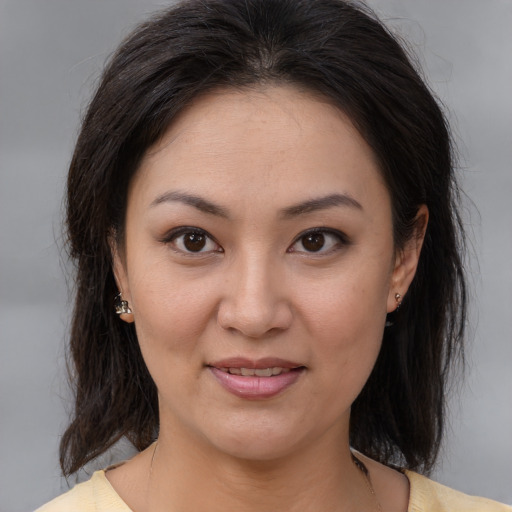 Joyful asian young-adult female with medium  brown hair and brown eyes