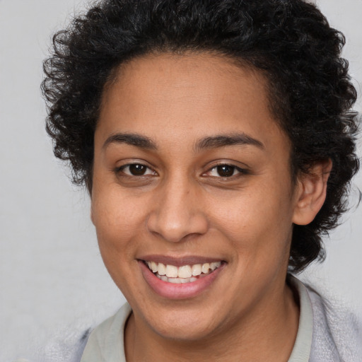 Joyful latino young-adult female with short  brown hair and brown eyes