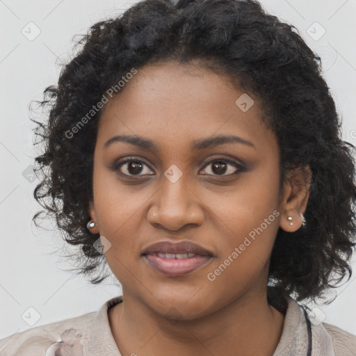 Joyful black young-adult female with long  black hair and brown eyes