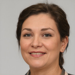 Joyful white adult female with medium  brown hair and brown eyes