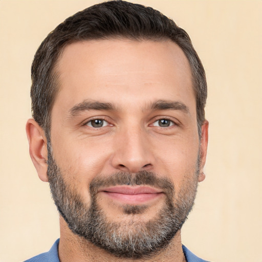 Joyful white adult male with short  brown hair and brown eyes