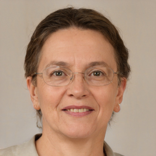 Joyful white middle-aged female with medium  brown hair and grey eyes