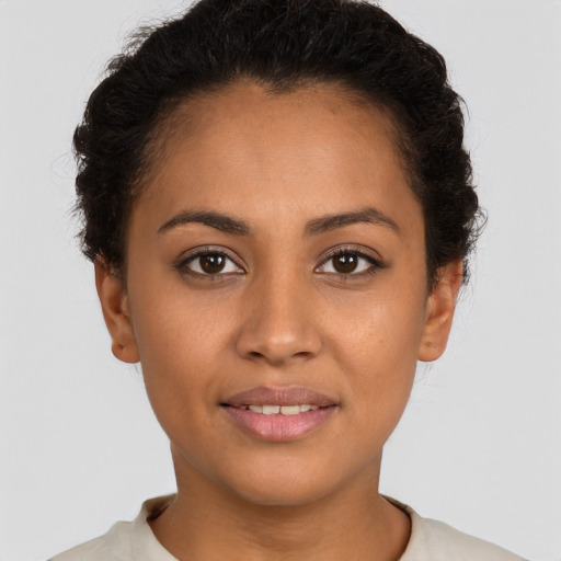 Joyful latino young-adult female with short  brown hair and brown eyes