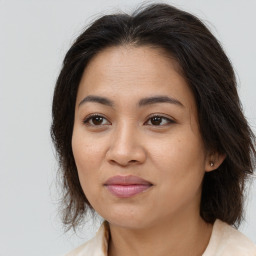 Joyful white adult female with medium  brown hair and brown eyes