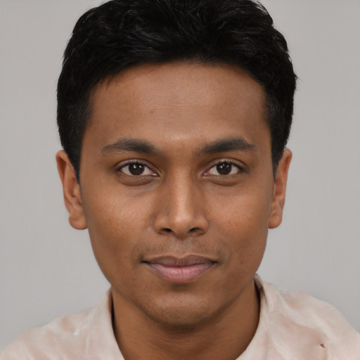 Joyful black young-adult male with short  black hair and brown eyes