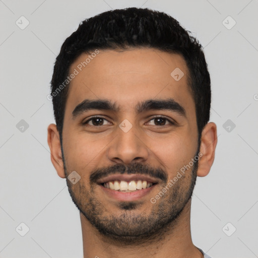 Joyful latino young-adult male with short  black hair and brown eyes