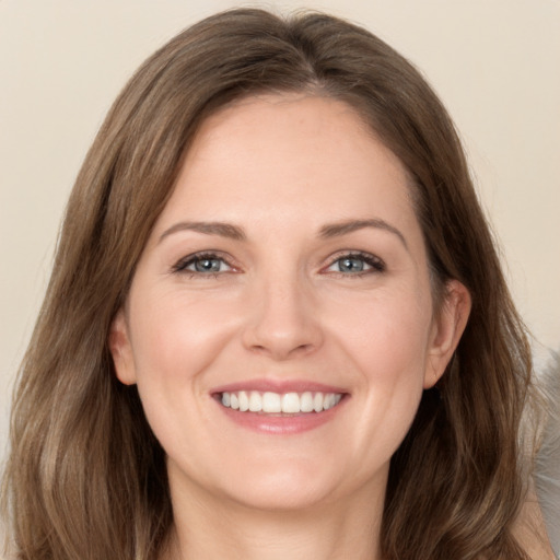 Joyful white young-adult female with long  brown hair and grey eyes