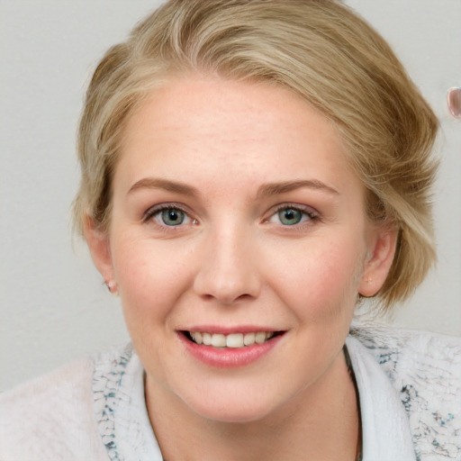 Joyful white young-adult female with medium  brown hair and blue eyes