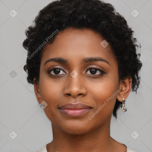 Joyful black young-adult female with short  black hair and brown eyes