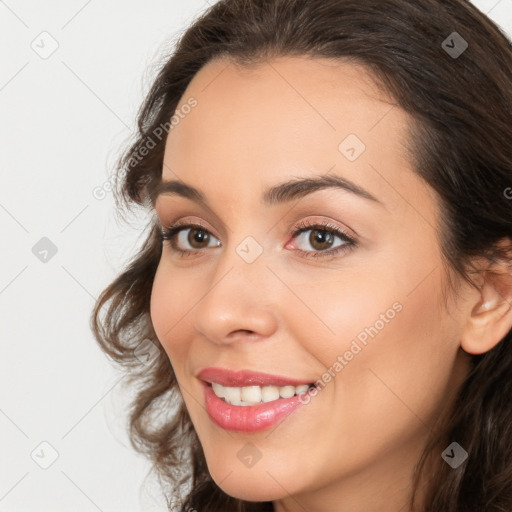 Joyful white young-adult female with long  brown hair and brown eyes