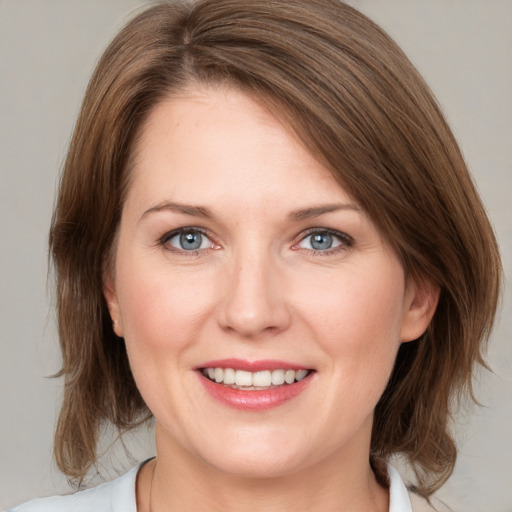 Joyful white young-adult female with medium  brown hair and grey eyes