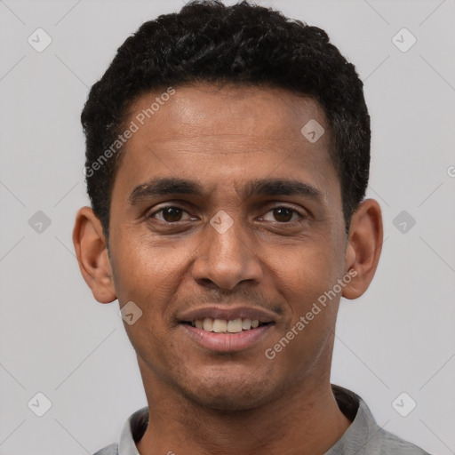 Joyful black young-adult male with short  black hair and brown eyes