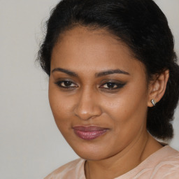 Joyful black young-adult female with medium  brown hair and brown eyes