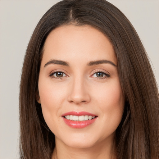 Joyful white young-adult female with long  brown hair and brown eyes