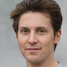 Joyful white adult male with short  brown hair and grey eyes