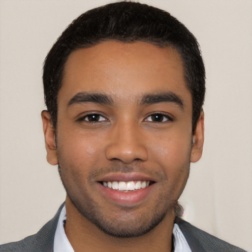 Joyful latino young-adult male with short  black hair and brown eyes