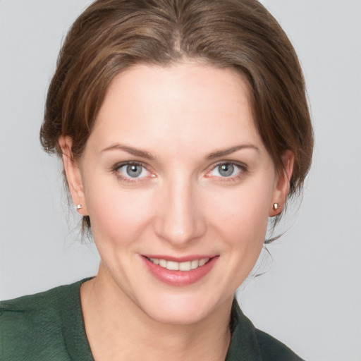 Joyful white young-adult female with medium  brown hair and grey eyes