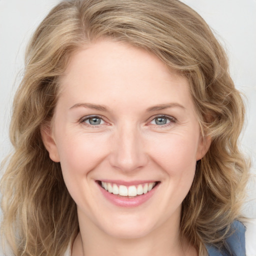 Joyful white young-adult female with medium  brown hair and blue eyes