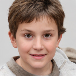 Joyful white child male with short  brown hair and grey eyes