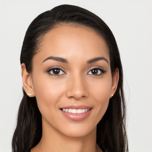 Joyful latino young-adult female with long  brown hair and brown eyes