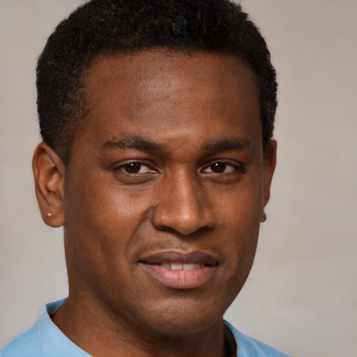 Joyful black young-adult male with short  brown hair and brown eyes