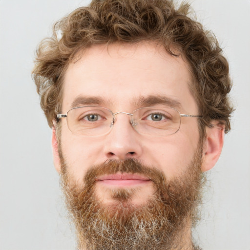 Joyful white adult male with short  brown hair and green eyes