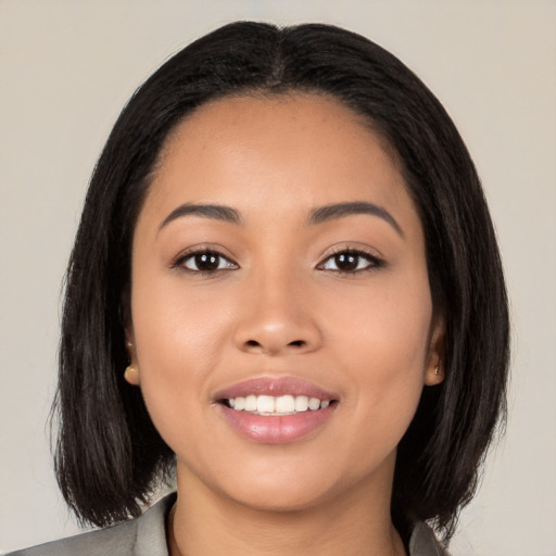 Joyful latino young-adult female with medium  black hair and brown eyes